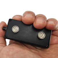 Black Vox Combo being held in a hand to show size.  Super strong magnets on the back.