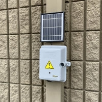 Cable Box Camera and Solar Panel Mounted on a Wall